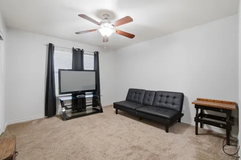 a living room with furniture and a piano