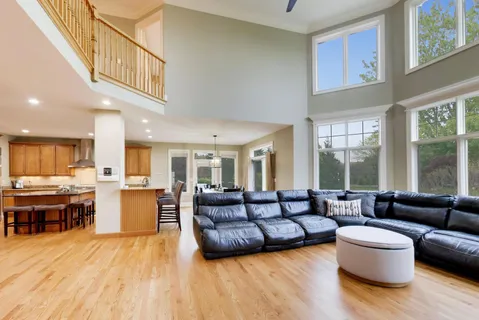 a living room with furniture flat screen tv and a large window