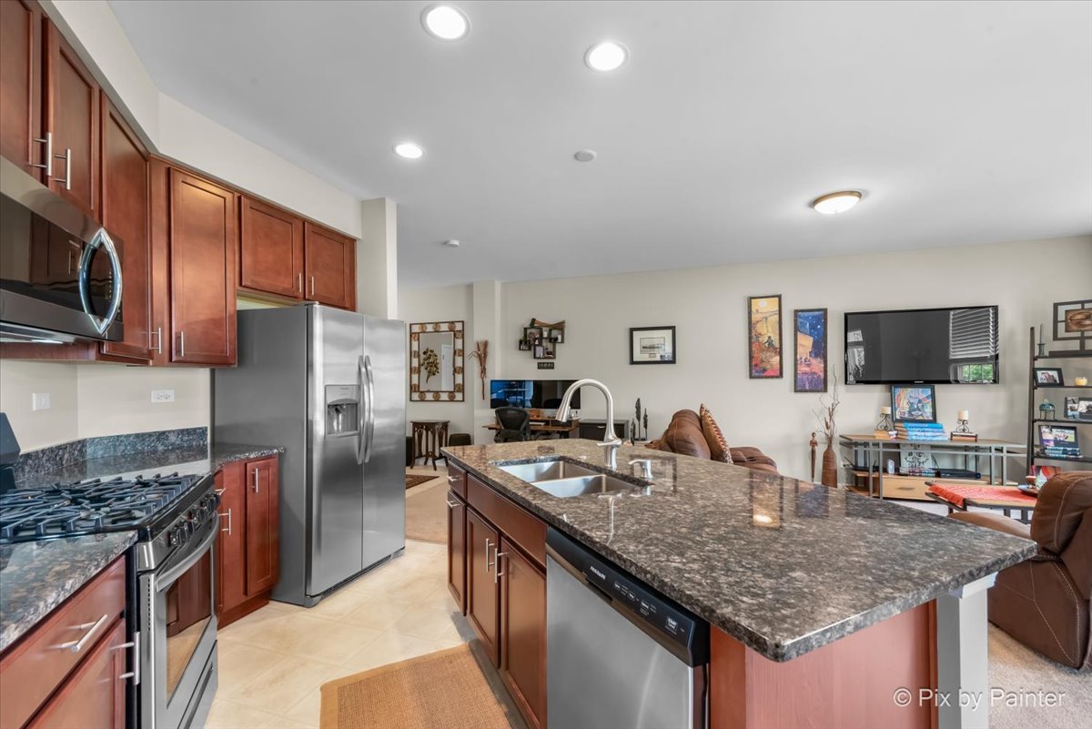 2911 Church Road Aurora, IL 60502 - Photo 8 of 37 a kitchen with stainless steel appliances granite countertop a sink stove and refrigerator
