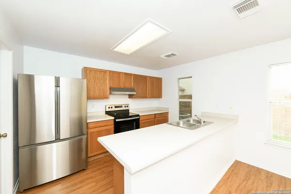 a kitchen with stainless steel appliances a refrigerator sink and stove