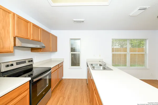 a kitchen with a sink a counter top space and appliances