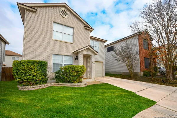 a front view of house with yard and green space