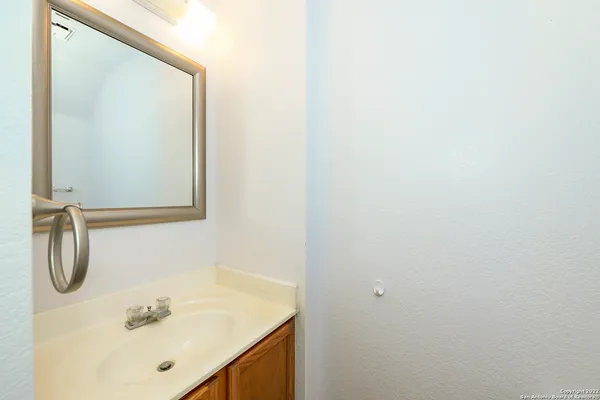 a bathroom with a sink vanity and shower