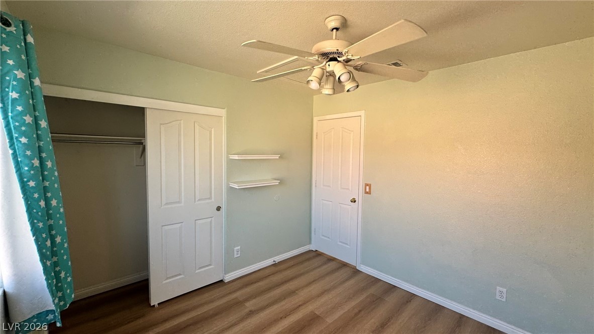 9716 Ridge Creek Place Las Vegas, NV 89134 - Photo 19 of 28 This spacious room features ample natural light and durable flooring, offering versatile design possibilities.
