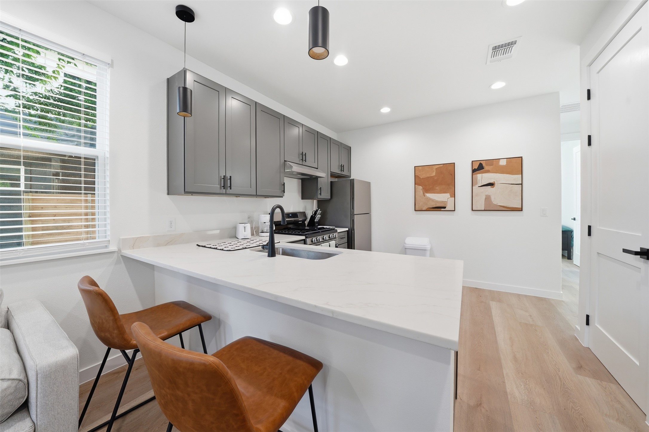 2216 Yellow Jacket Lane, Unit 2 Austin, TX 78741 - Photo 7 of 25 a kitchen with stainless steel appliances kitchen island granite countertop a sink and a refrigerator