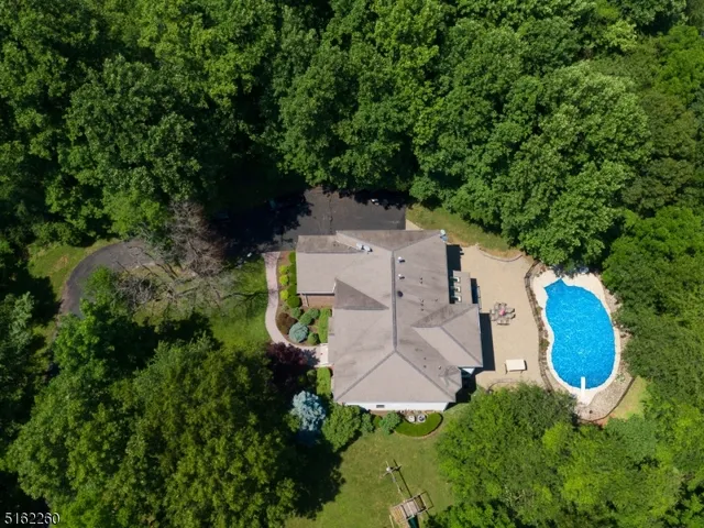 an aerial view of a house with a yard and outdoor seating