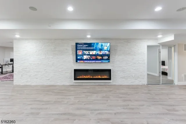 a view of a living room with furniture and a flat screen tv