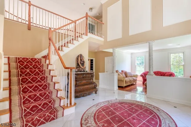 a living room with furniture and stairs