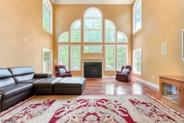a living room with furniture fireplace and a large window