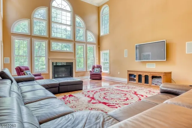 a living room with furniture fireplace and a large window