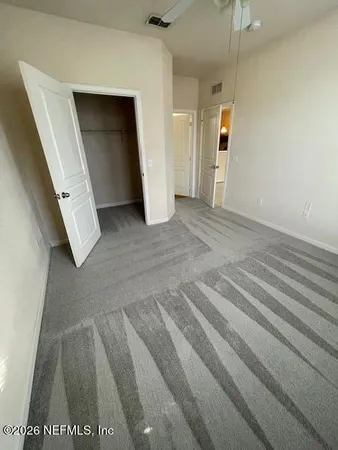 a view of a street with wooden fence