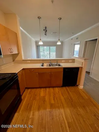a kitchen with wooden floors and a sink