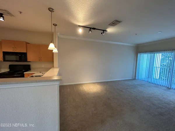 a view of a kitchen with a sink and a fireplace