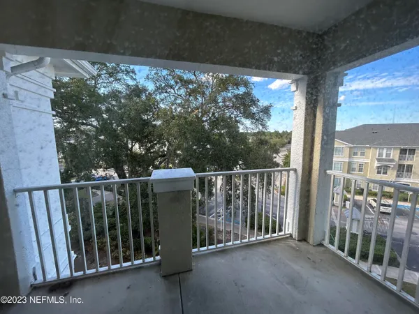 a view of a porch with wooden floor