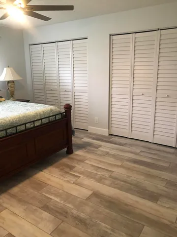 a spacious bedroom with a bed and a window