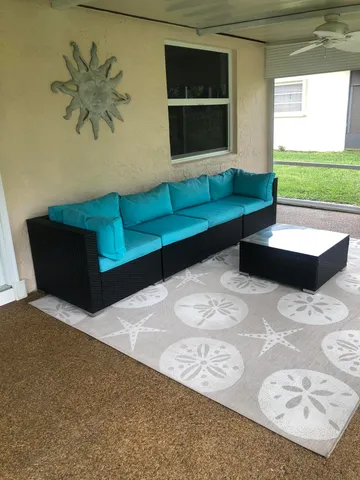 a living room with couch and a large window