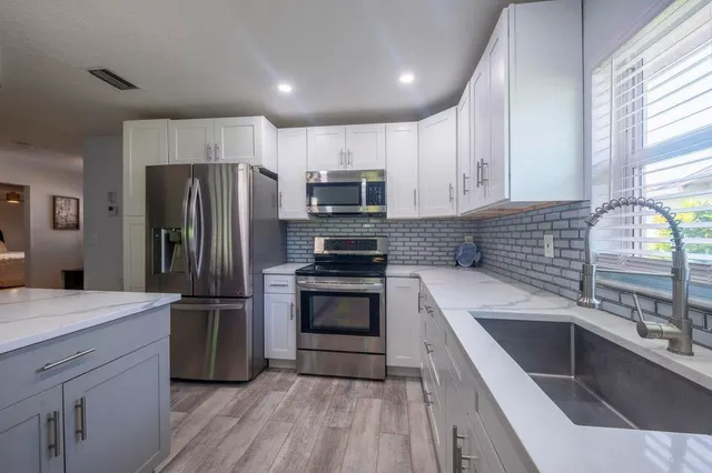 a kitchen with a refrigerator sink and microwave