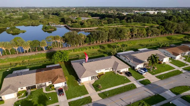 an aerial view of multiple houses with yard