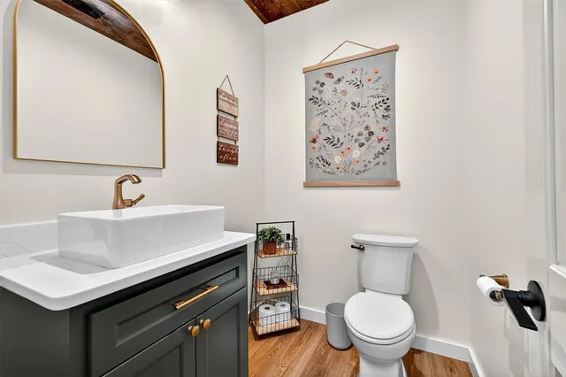 a bathroom with a sink toilet and a mirror