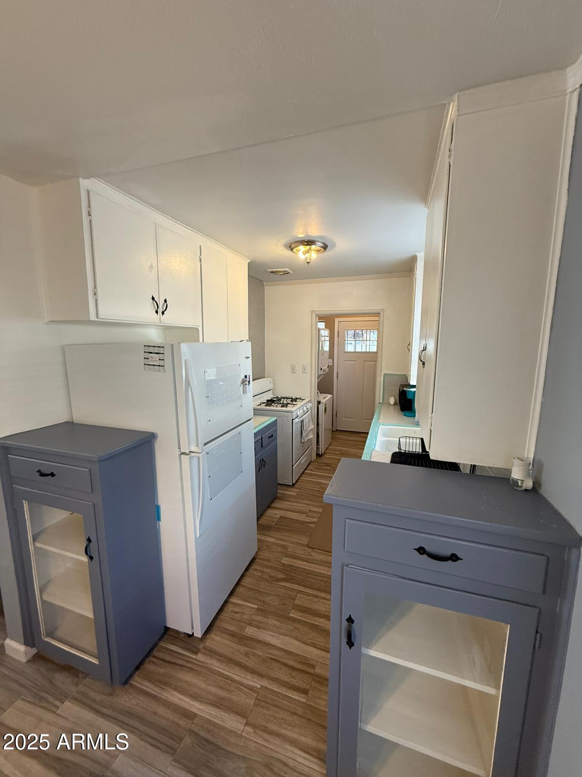 1224 F Avenue Douglas, AZ 85607 - Photo 13 of 16 a kitchen with a refrigerator sink and cabinets