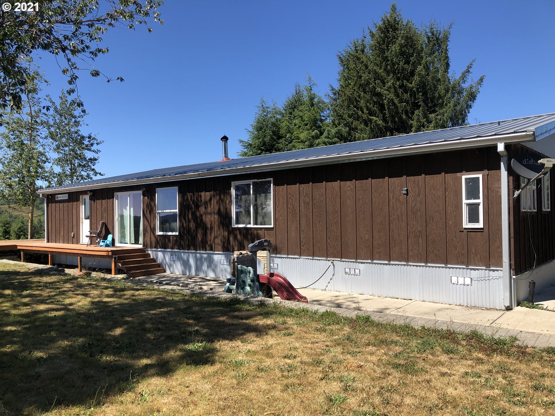8245 Burbank Road Tillamook, OR 97141 - Photo 1 of 28 a view of a house with backyard and sitting area