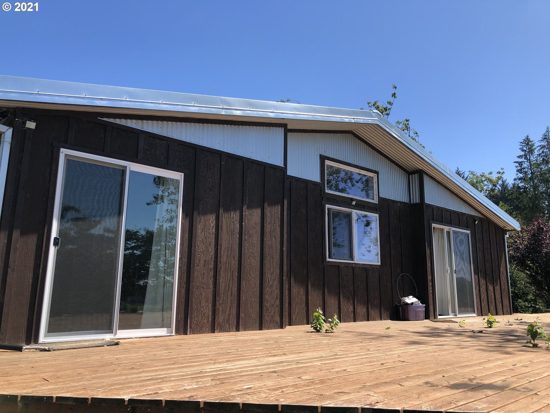 8245 Burbank Road Tillamook, OR 97141 - Photo 2 of 28 a view of a brick house with a outdoor space
