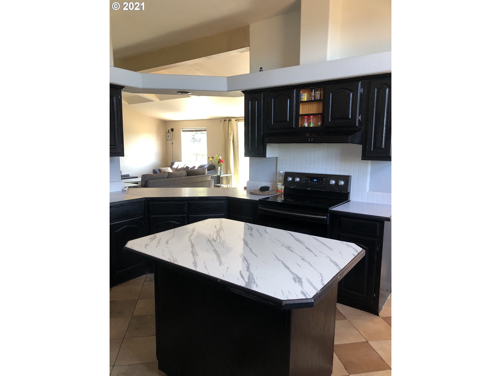 8245 Burbank Road Tillamook, OR 97141 - Photo 14 of 28 a kitchen with a sink and cabinets