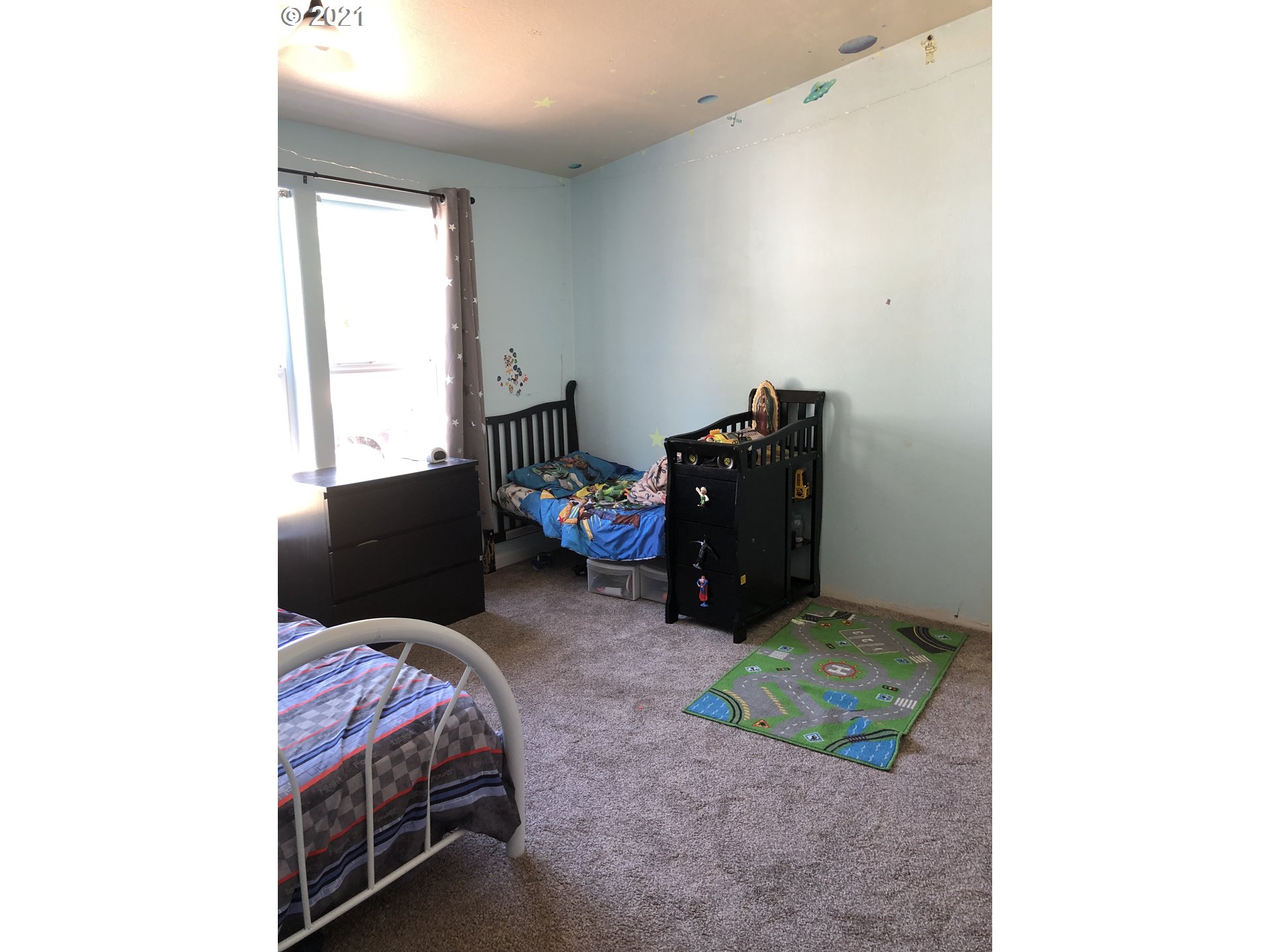8245 Burbank Road Tillamook, OR 97141 - Photo 19 of 28 a bed room with a bed and a television