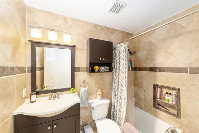 a bathroom with a sink mirror vanity and toilet