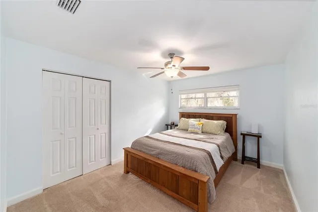 a bed sitting in a bedroom next to a window