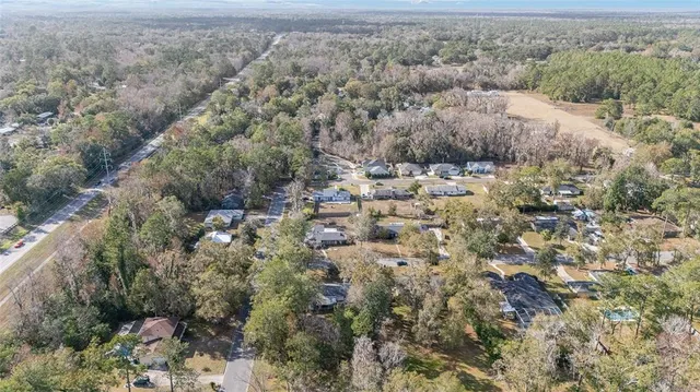 an aerial view of house with yard and mountain view