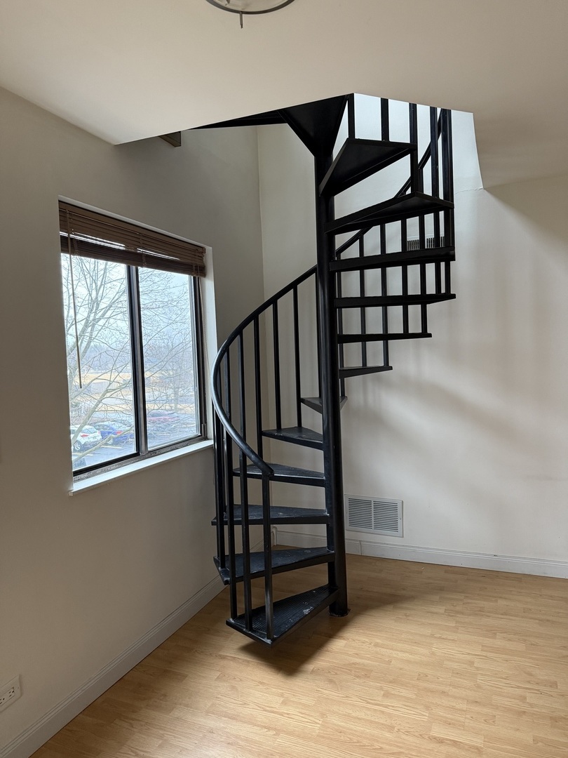 383 Wilmington Drive, Unit E Bartlett, IL 60103 - Photo 4 of 17 a view of entryway with wooden floor and stairs