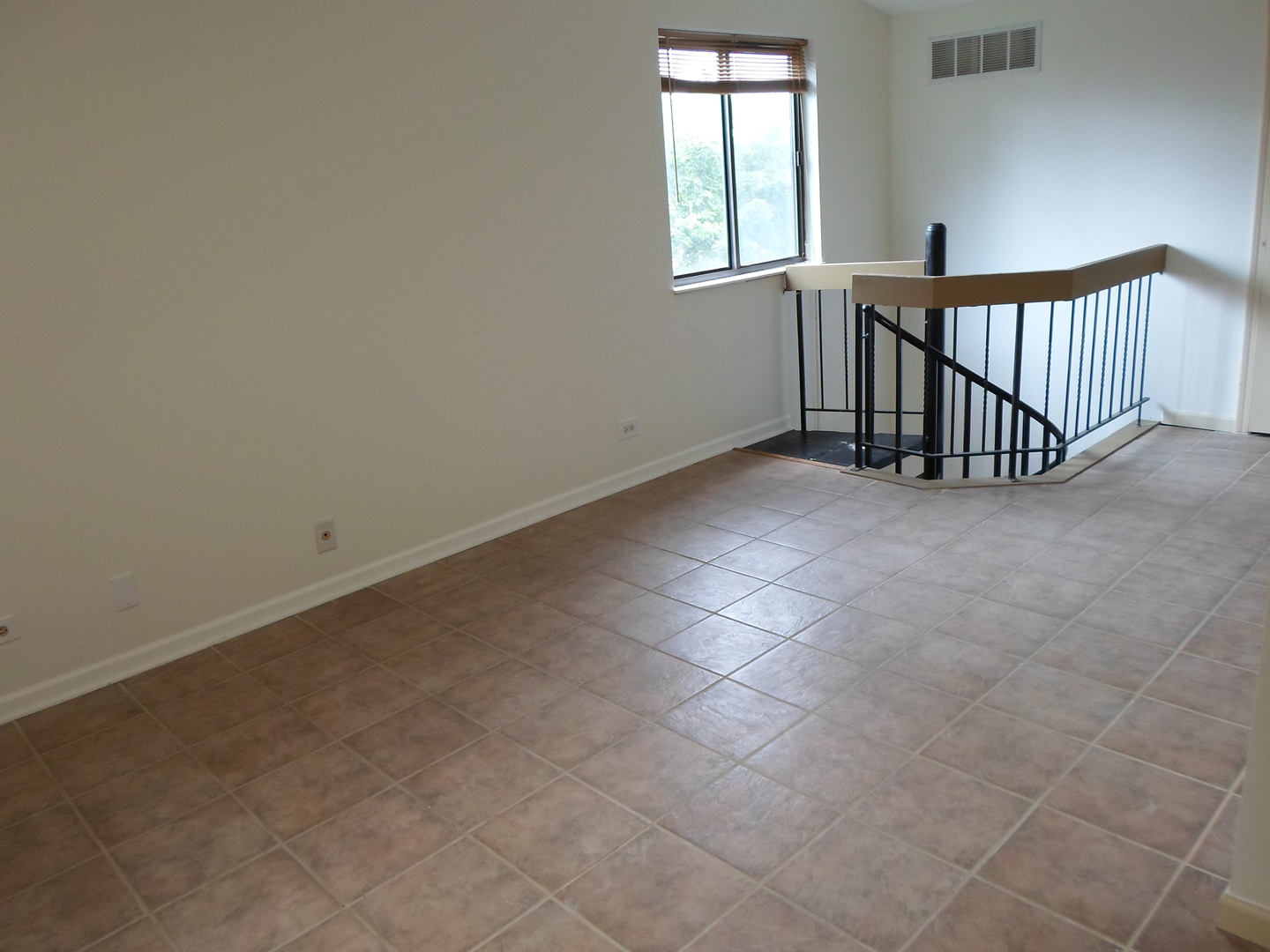 383 Wilmington Drive, Unit E Bartlett, IL 60103 - Photo 7 of 17 an empty room with windows