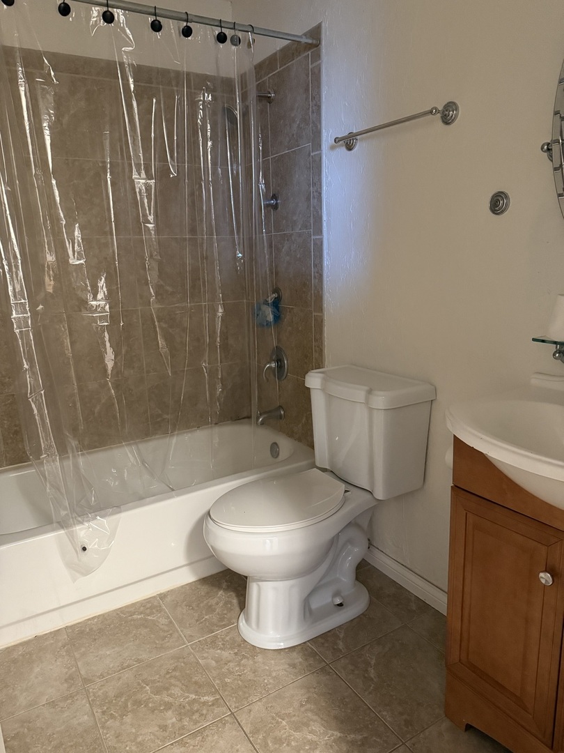 383 Wilmington Drive, Unit E Bartlett, IL 60103 - Photo 10 of 17 a bathroom with a toilet and a shower