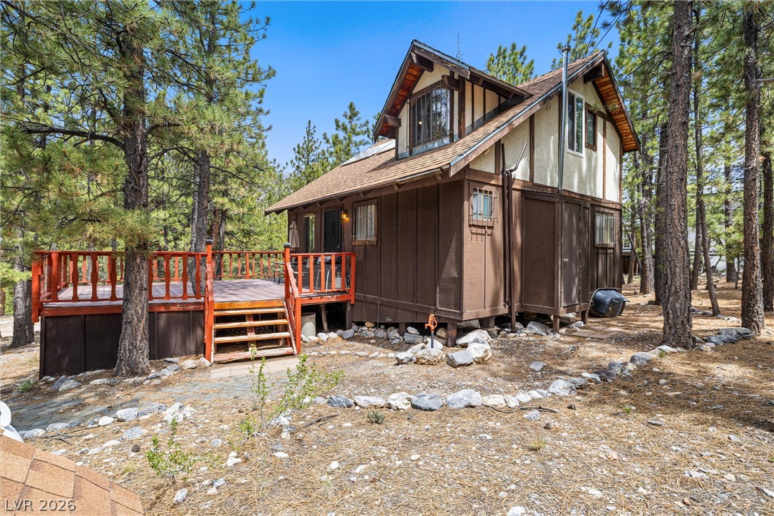 2146 Via Spes Nostra Street Mount Charleston, NV 89124 - Photo 4 of 33 A secluded cabin surrounded by mature pines features a spacious outdoor deck for peaceful enjoyment.