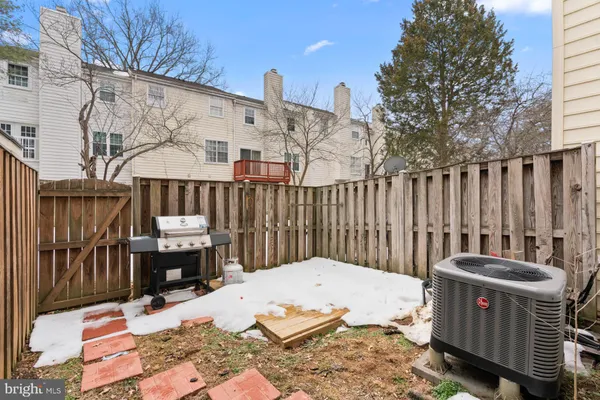 a view of a roof deck with wooden fence and floor