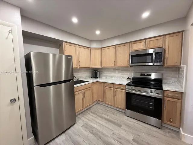 a kitchen with a refrigerator stove and microwave