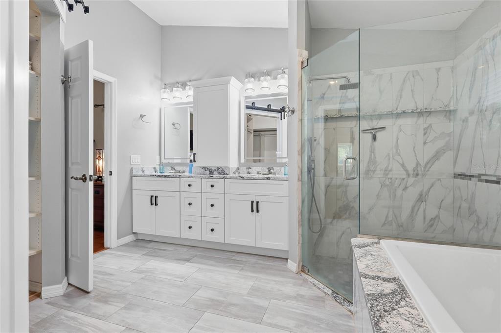 3488 Ridge Boulevard Palm Harbor, FL 34684 - Photo 18 of 30 a bathroom with a double vanity sink toilet and shower