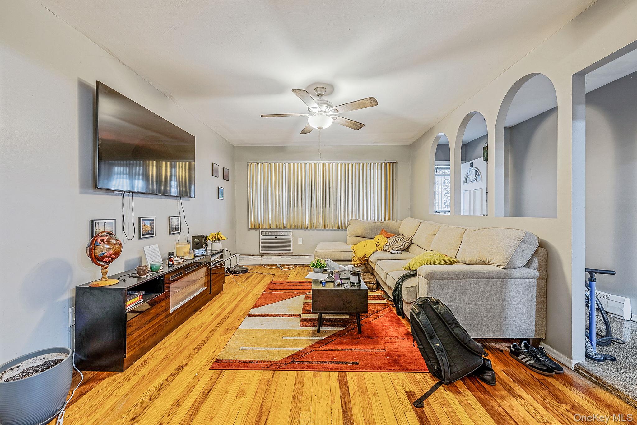 2070 Ralph Avenue Brooklyn, NY 11234 - Photo 11 of 48 a living room with a couch and a flat screen tv