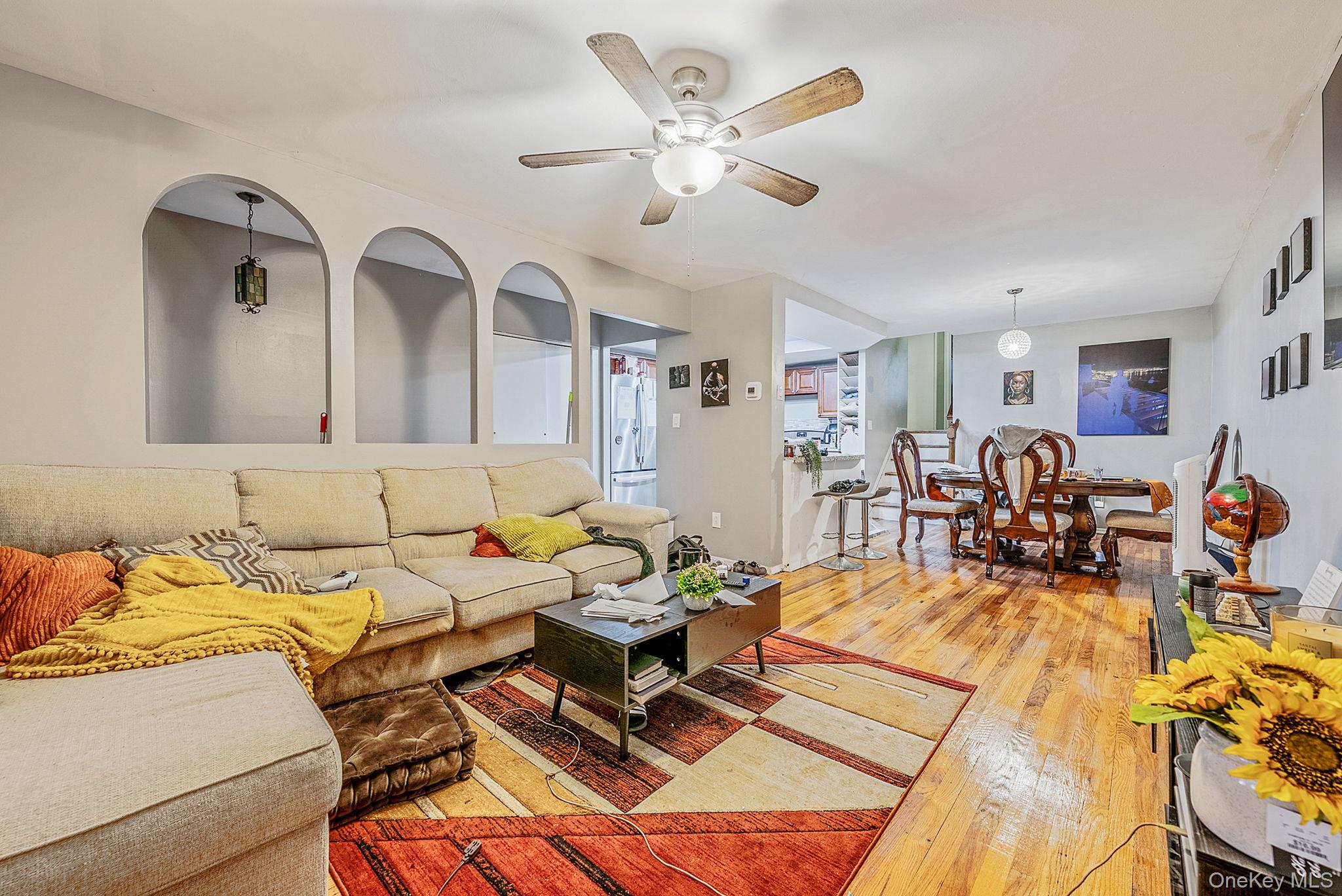 2070 Ralph Avenue Brooklyn, NY 11234 - Photo 15 of 48 a living room with furniture kitchen view and a chandelier