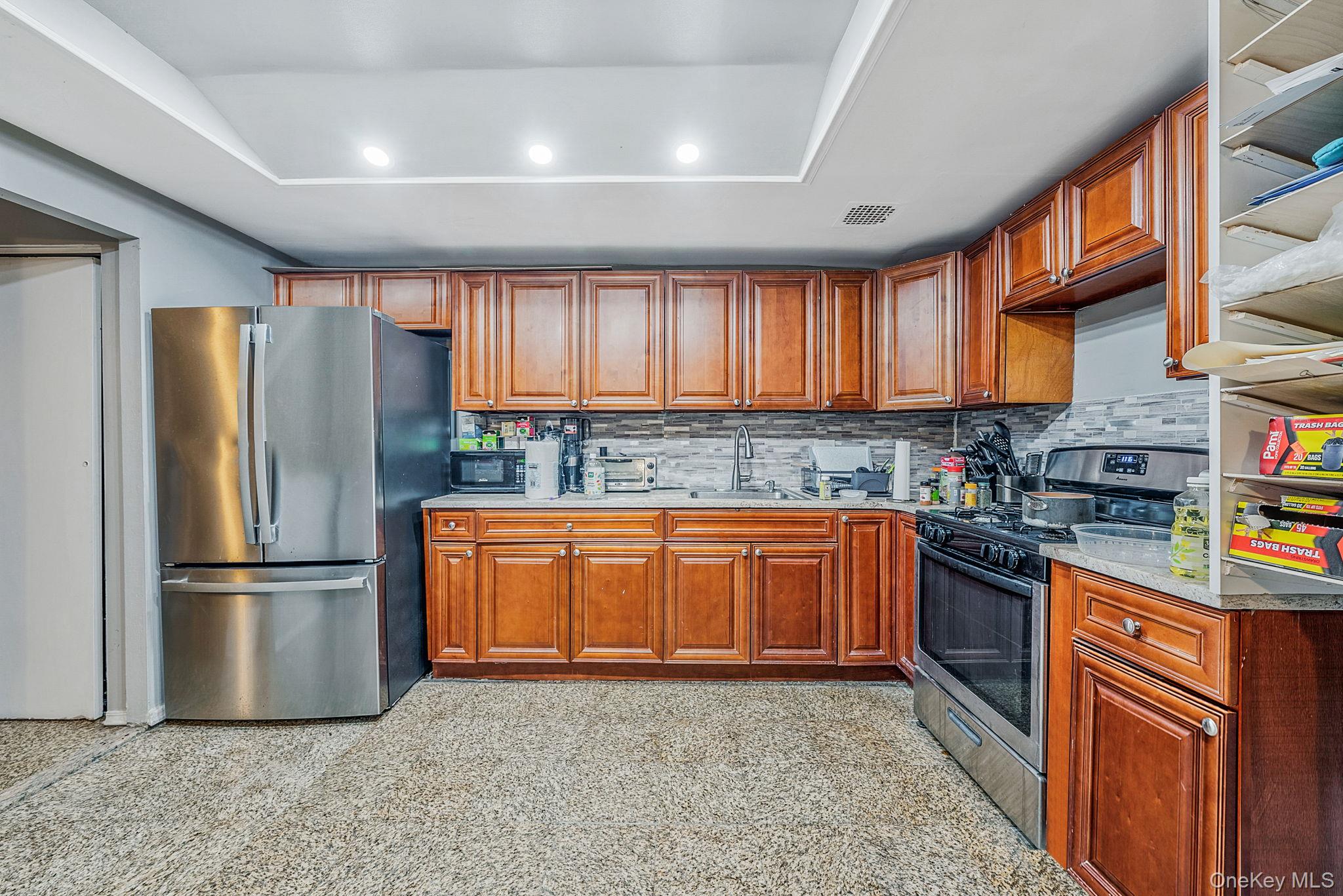 2070 Ralph Avenue Brooklyn, NY 11234 - Photo 22 of 48 a kitchen with stainless steel appliances granite countertop a refrigerator stove top oven a sink and dishwasher