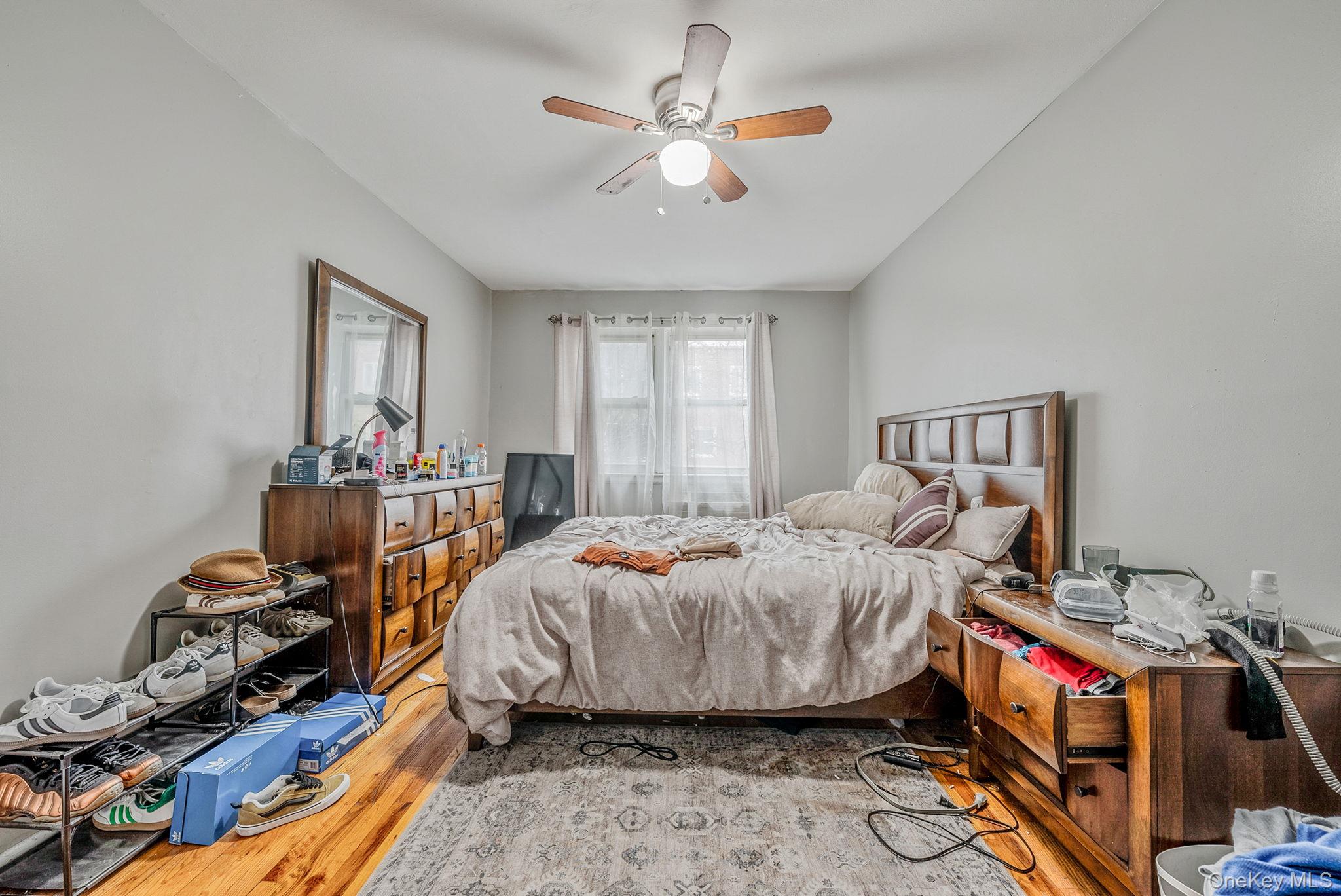 2070 Ralph Avenue Brooklyn, NY 11234 - Photo 26 of 48 a bedroom with bed and a chandelier