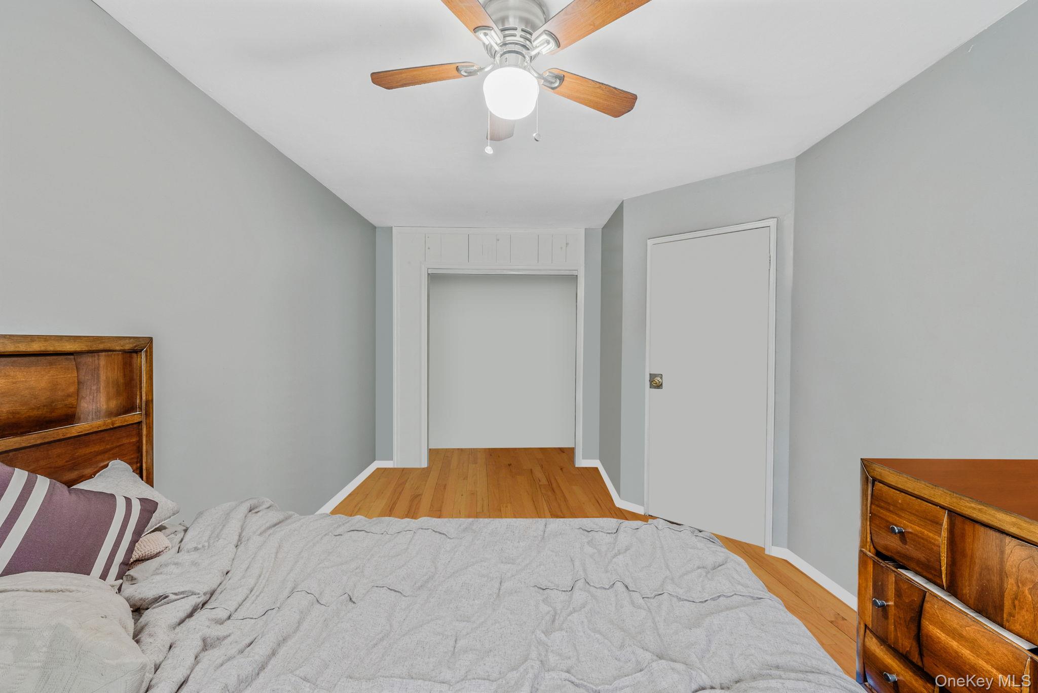 2070 Ralph Avenue Brooklyn, NY 11234 - Photo 29 of 48 a bedroom with a bed and a chandelier