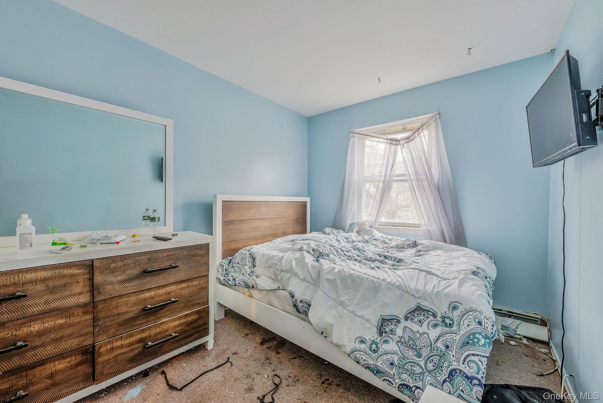 2070 Ralph Avenue Brooklyn, NY 11234 - Photo 32 of 48 a bedroom with a bed and a flat tv screen on a dresser