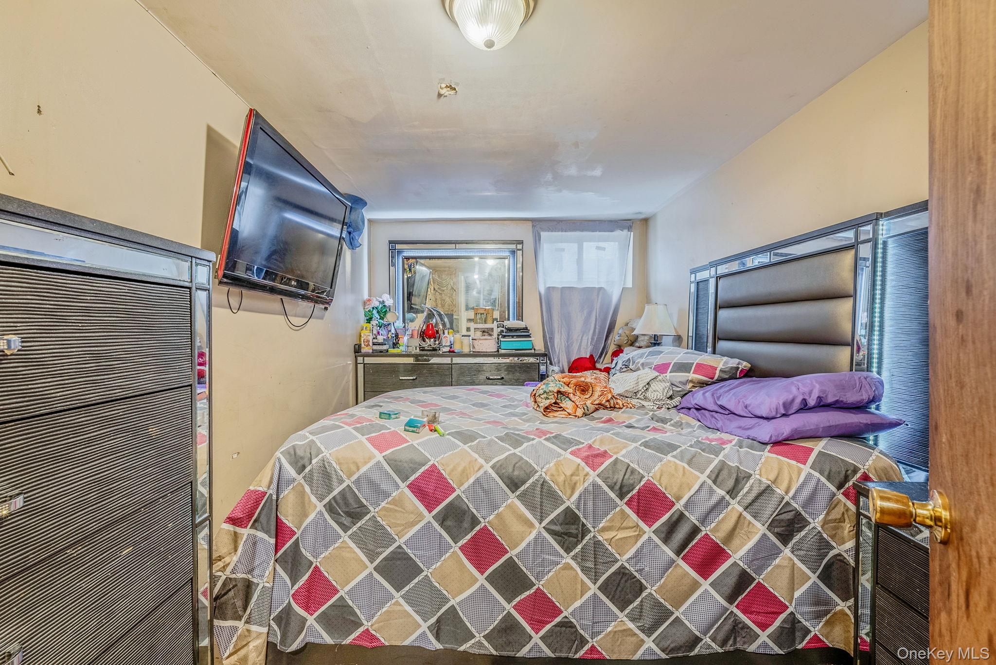 2070 Ralph Avenue Brooklyn, NY 11234 - Photo 35 of 48 a bedroom with bed and a window