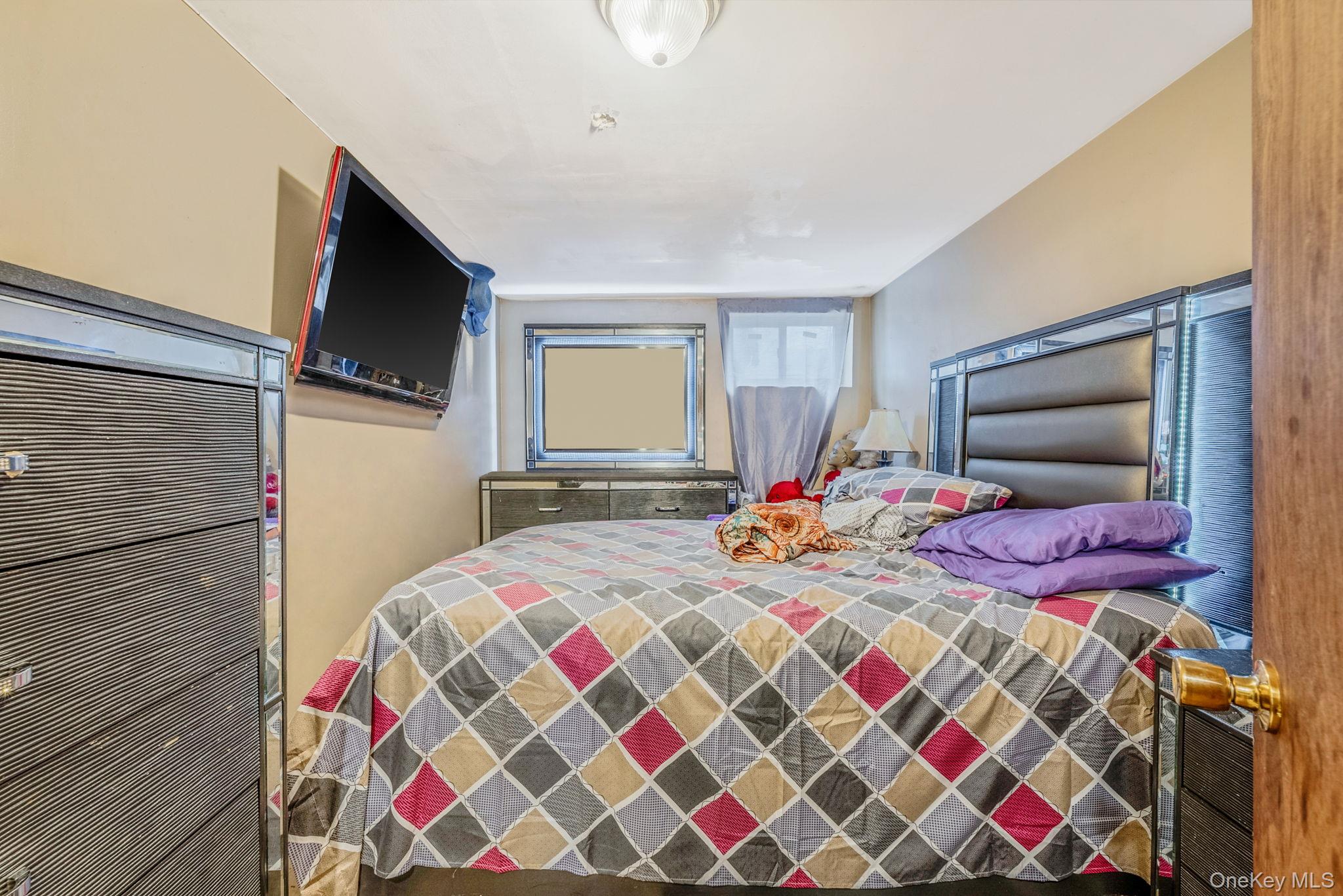 2070 Ralph Avenue Brooklyn, NY 11234 - Photo 36 of 48 a bedroom with bed and a flat screen tv