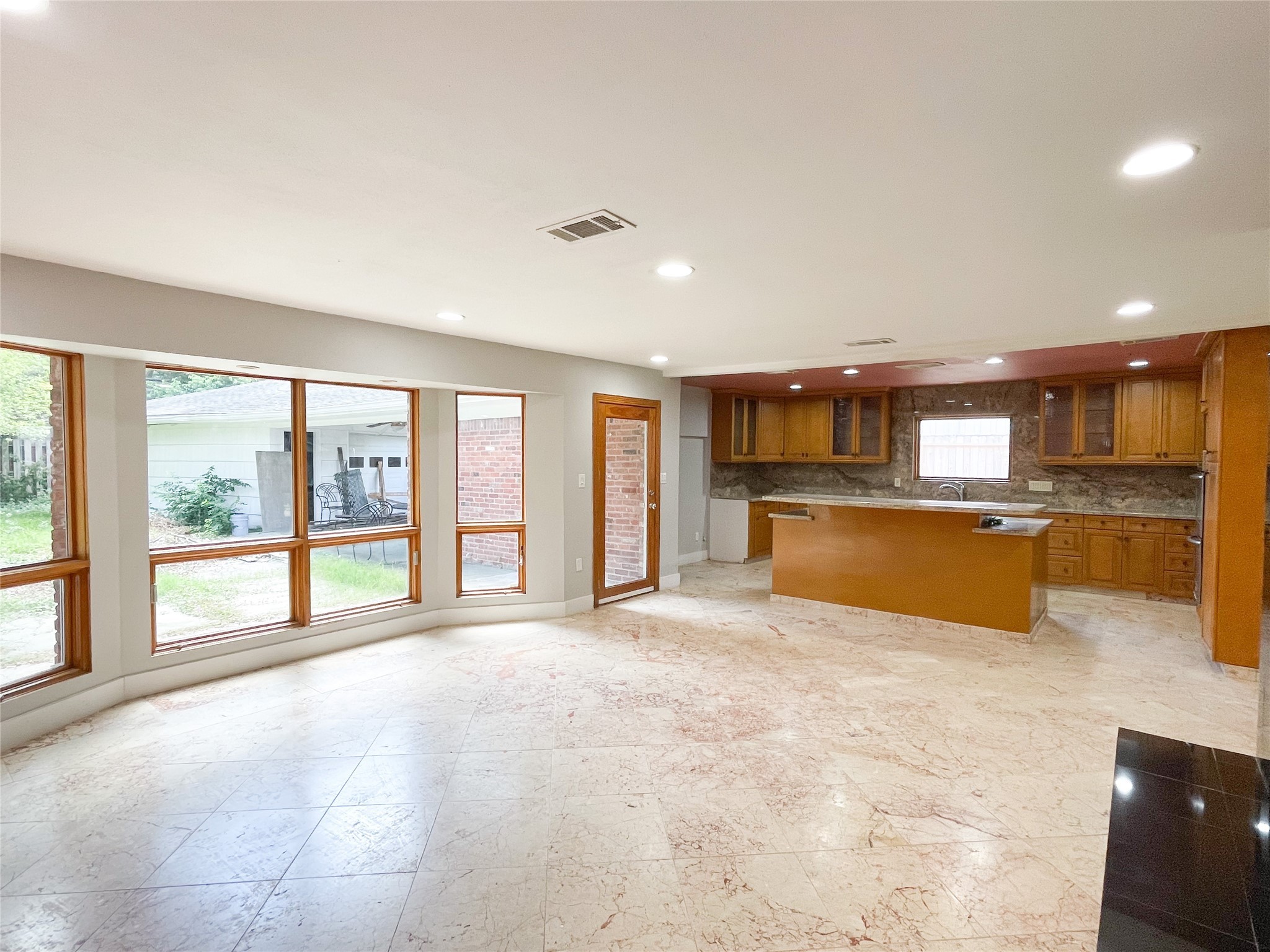 5011 Imogene Street Houston, TX 77096 - Photo 4 of 13 a large white kitchen with a large window and kitchen view