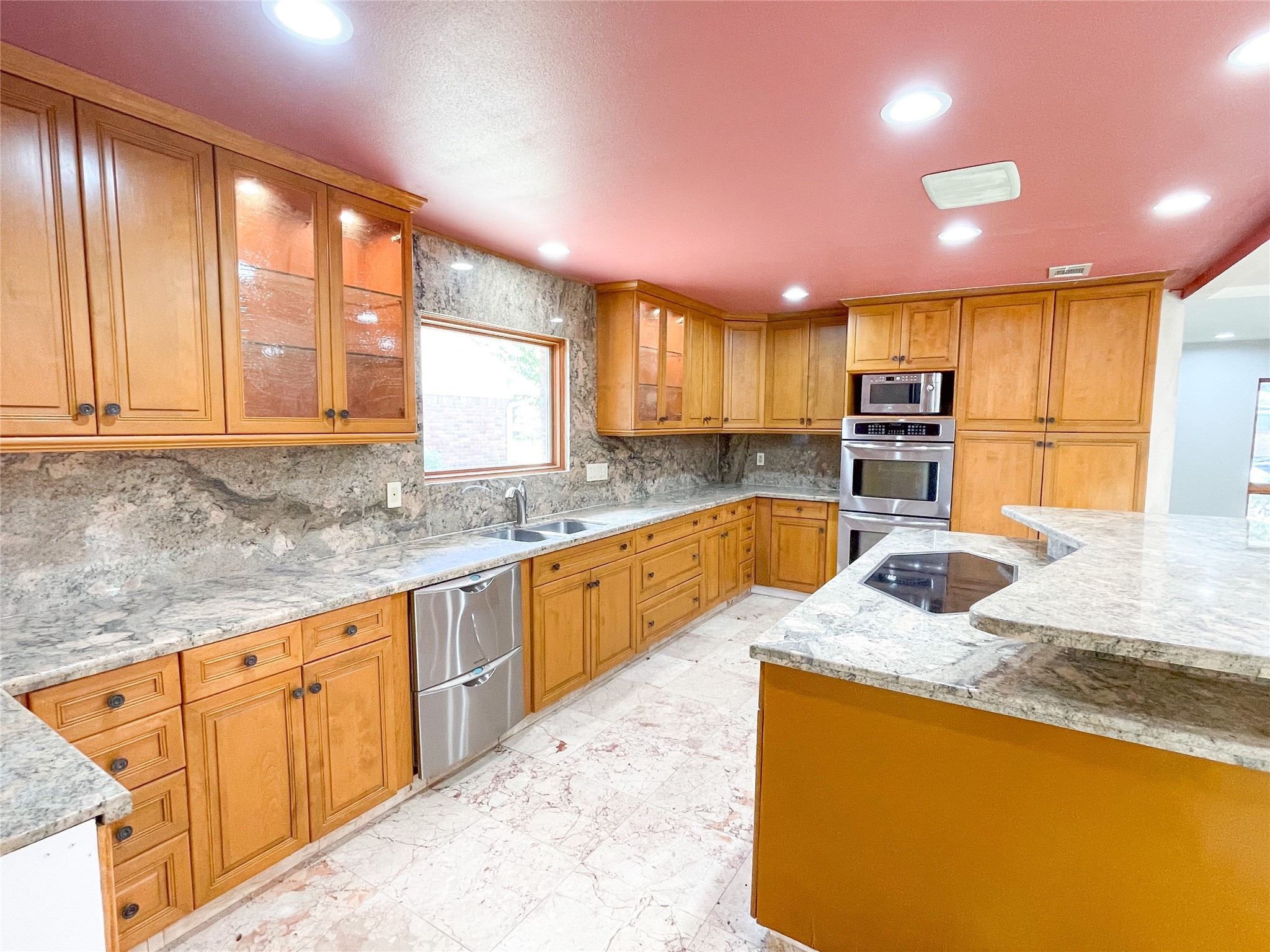 5011 Imogene Street Houston, TX 77096 - Photo 6 of 13 a large kitchen with granite countertop a sink and cabinets