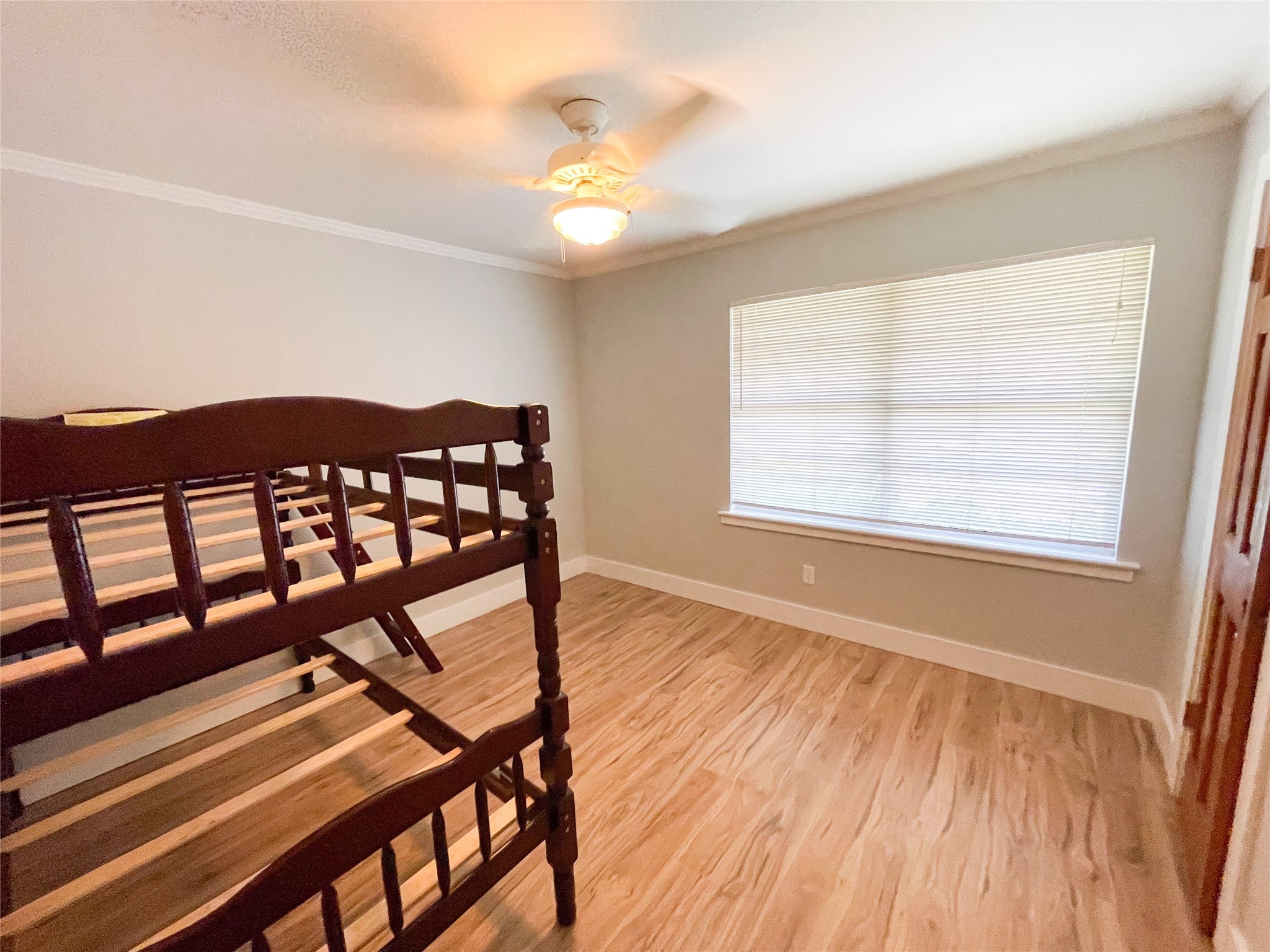 5011 Imogene Street Houston, TX 77096 - Photo 8 of 13 a view of an empty room with wooden floor and a window