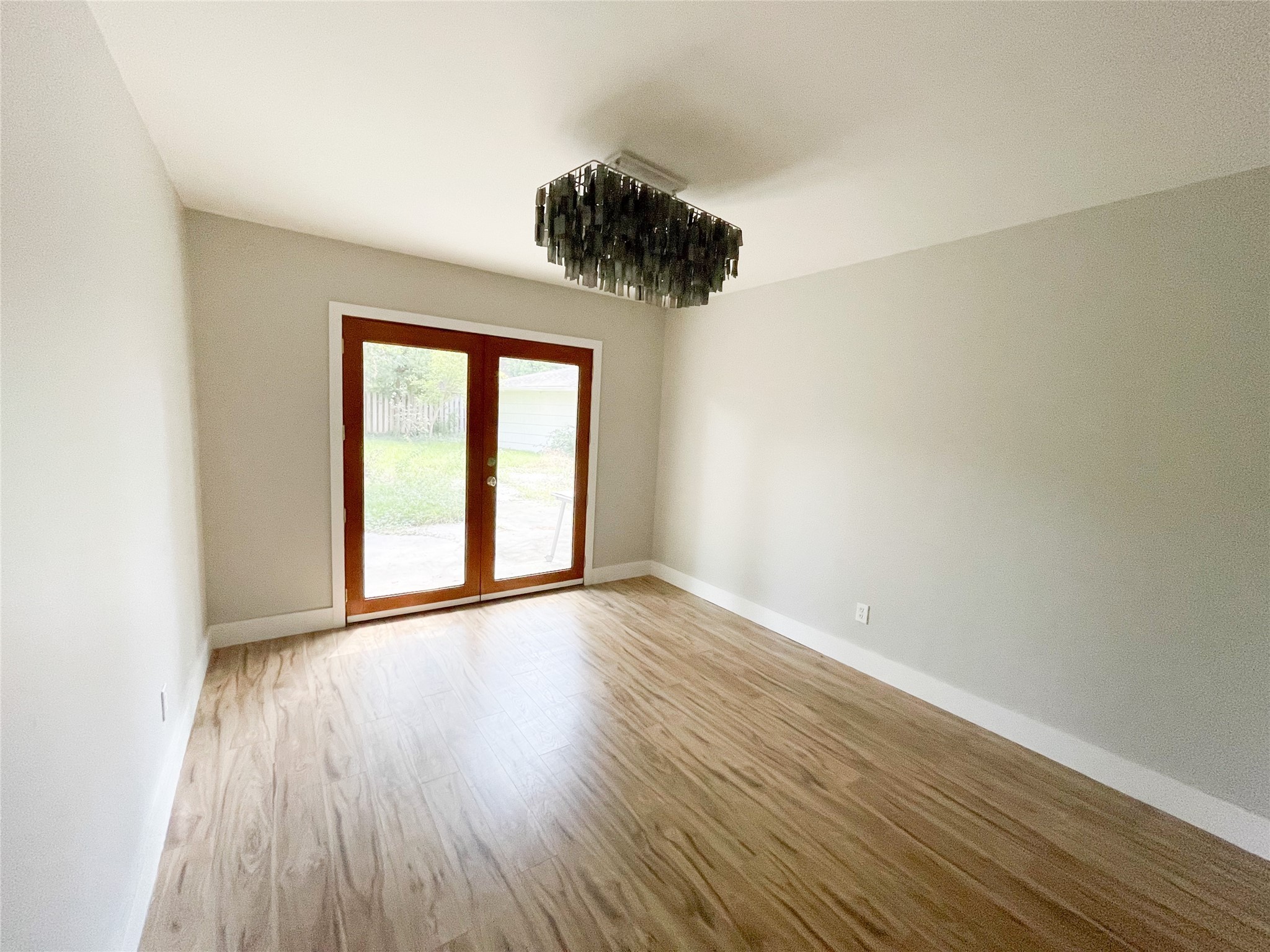 5011 Imogene Street Houston, TX 77096 - Photo 9 of 13 wooden floor in an empty room with a window